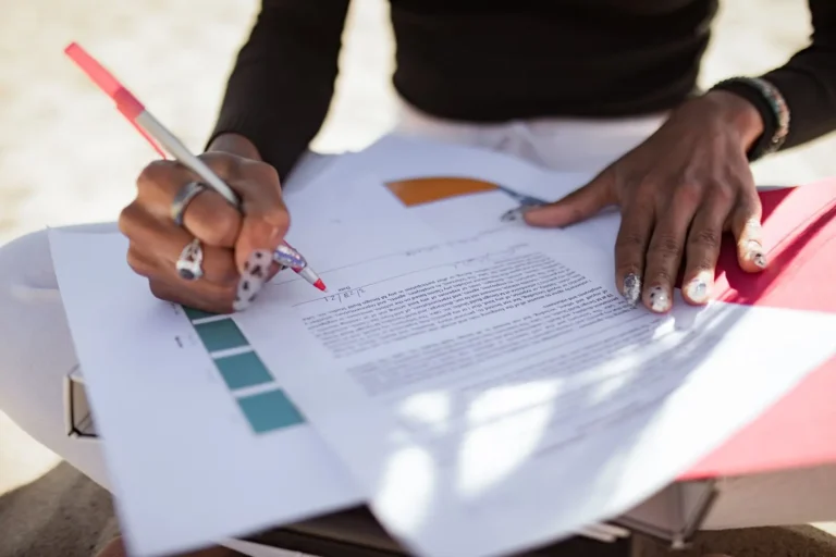 Hand writing corrections on a printed page