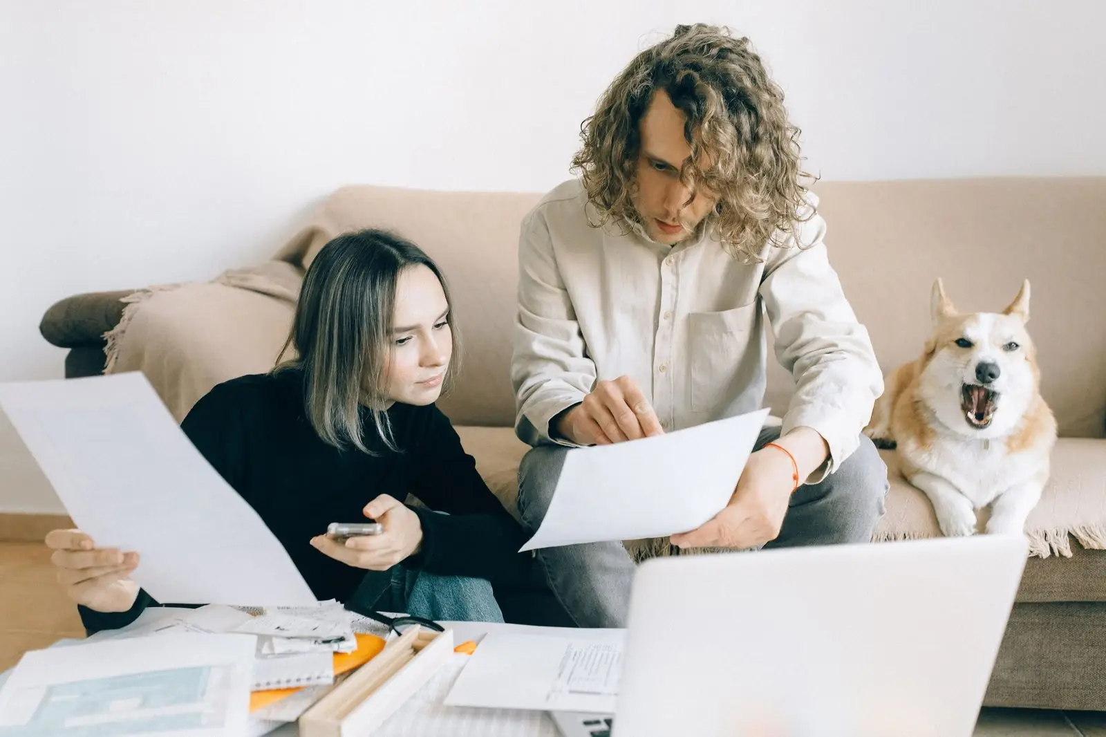 Couple going through papers together on the floor at home