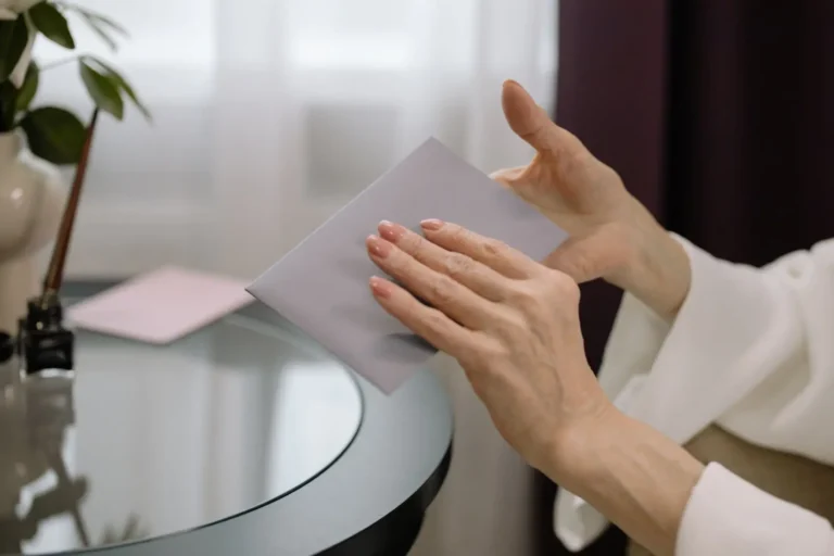 Hands opening an envelope
