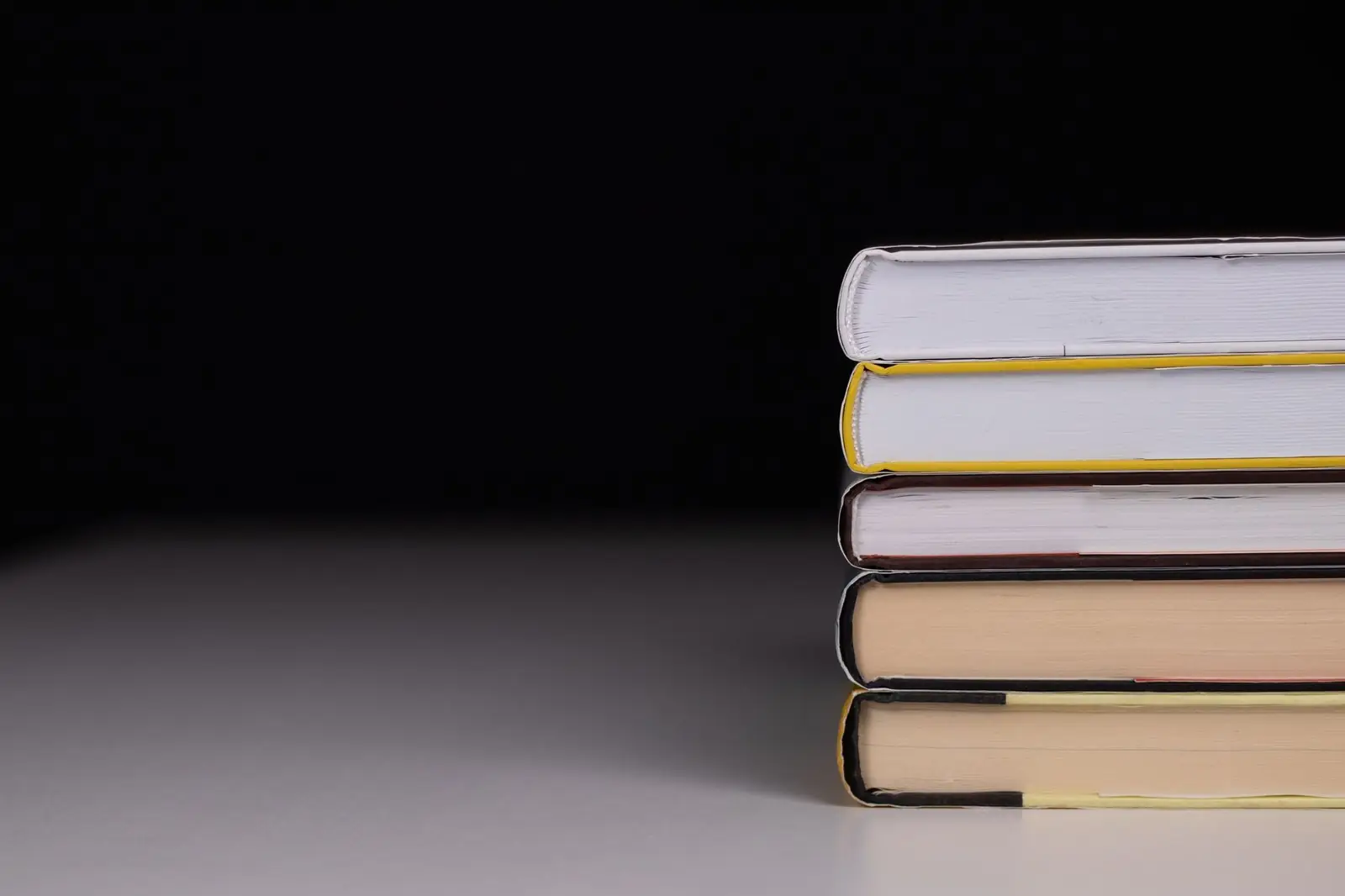 Small stack of books on a dark table