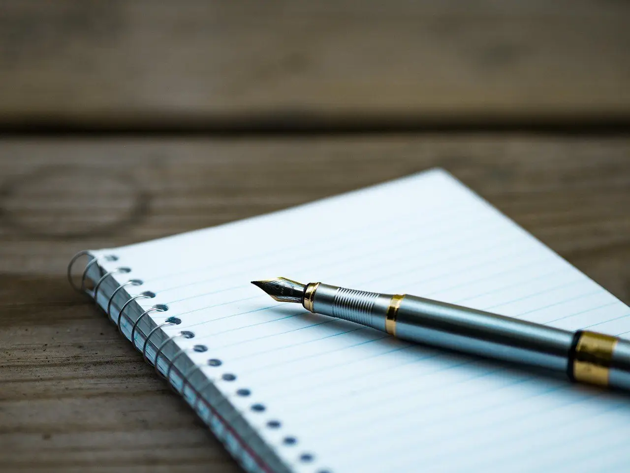 Fountain pen on a blank notebook page